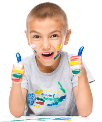 Image showing Portrait of a cute boy playing with paints