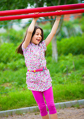 Image showing Cute little girl is playing in playground