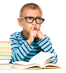 Image showing Little boy is reading a book