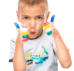 Image showing Portrait of a cute boy playing with paints