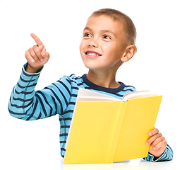 Image showing Little boy is reading a book