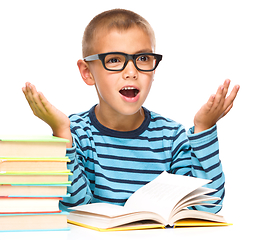 Image showing Little boy is reading a book