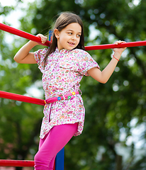 Image showing Cute little girl is playing in playground