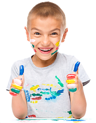 Image showing Portrait of a cute boy playing with paints