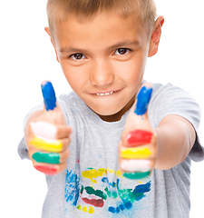 Image showing Portrait of a cute boy playing with paints