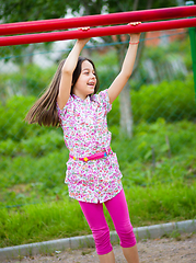 Image showing Cute little girl is playing in playground