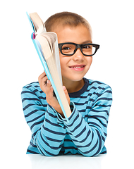 Image showing Little boy is reading a book