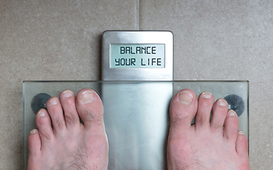 Image showing Man\'s feet on weight scale - Balance your life