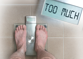 Image showing Man\'s feet on weight scale - Too much