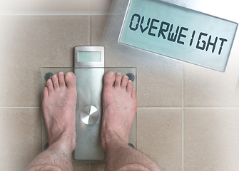 Image showing Man\'s feet on weight scale - Overweight