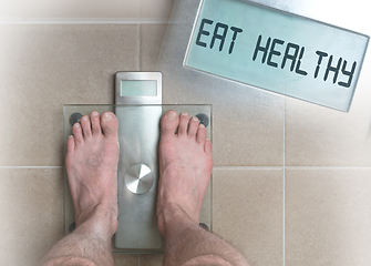 Image showing Man\'s feet on weight scale - Eat healthy