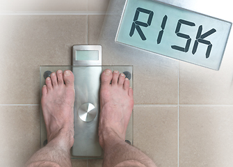 Image showing Man\'s feet on weight scale - Risk