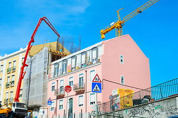 Image showing Construction cranes by appartment building