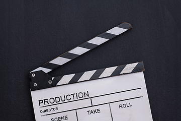 Image showing movie clapper on balck chalkboard background