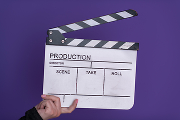 Image showing movie clapper on purple background