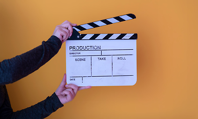 Image showing movie clapper on yellow background