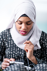 Image showing african  woman using smartphone at home