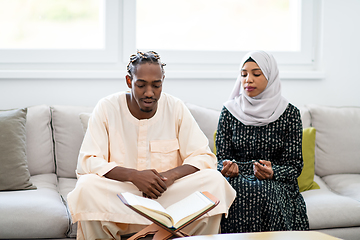 Image showing african couple at home reading quran