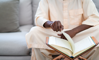 Image showing african couple at home reading quran