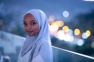 Image showing African  modern Muslim woman in night at balcony