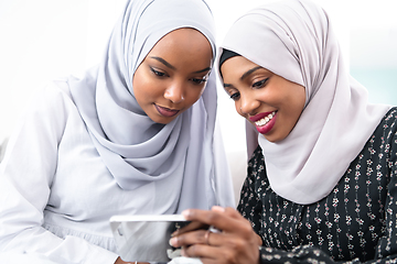 Image showing african  women using smartphone at home