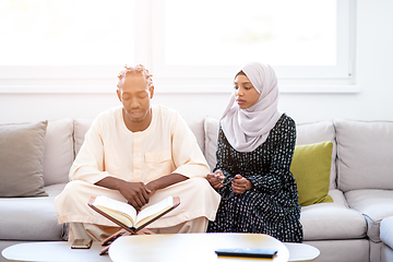 Image showing african couple at home reading quran