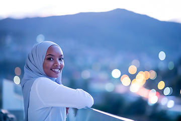 Image showing African  modern Muslim woman in night at balcony