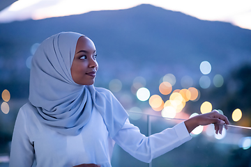 Image showing African  modern Muslim woman in night at balcony