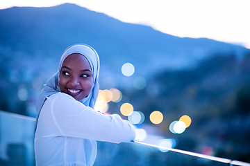 Image showing African  modern Muslim woman in night at balcony