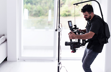 Image showing Professional videographer with gimball video slr recording video