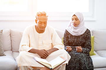 Image showing african couple at home reading quran