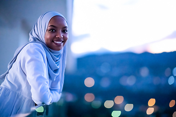 Image showing African  modern Muslim woman in night at balcony