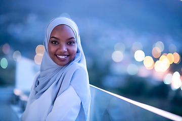 Image showing African  modern Muslim woman in night at balcony