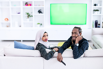 Image showing African Couple Sitting On Sofa Watching TV Together