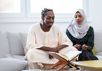 Image showing african couple at home reading quran