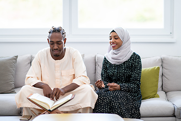 Image showing african couple at home reading quran