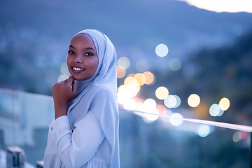 Image showing African  modern Muslim woman in night at balcony