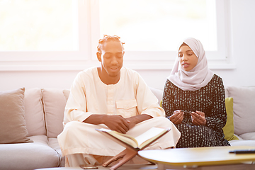 Image showing african couple at home reading quran