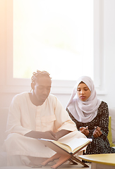 Image showing african couple at home reading quran