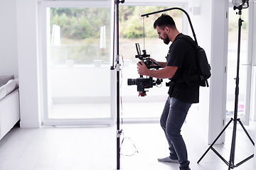 Image showing Professional videographer with gimball video slr recording video