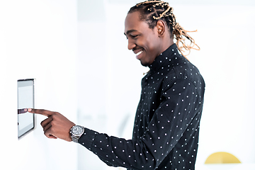 Image showing African man using smart home screen