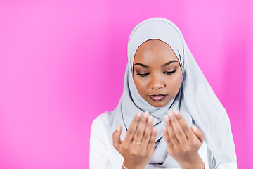 Image showing African Muslim woman makes traditional prayer to God