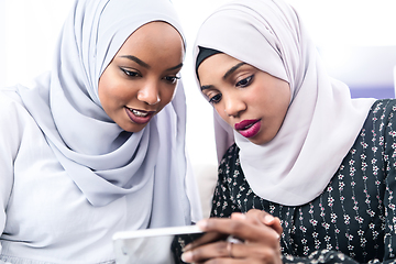 Image showing african  women using smartphone at home