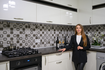 Image showing Young woman at luxury modern white kitchen interior in provence style