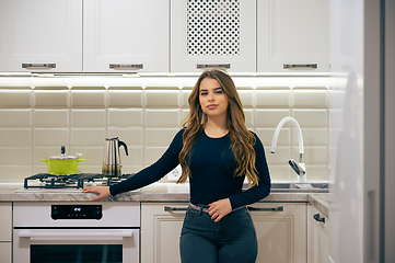 Image showing Young woman at luxury white classic kitchen interior