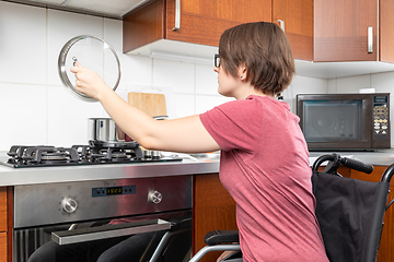 Image showing disabled woman cooking in the kitchen