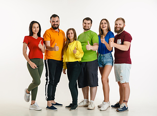 Image showing Young people weared in LGBT flag colors isolated on white background, LGBT pride concept