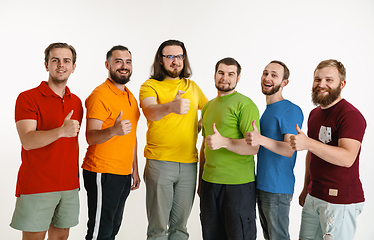 Image showing Young men weared in LGBT flag colors isolated on white background, LGBT pride concept