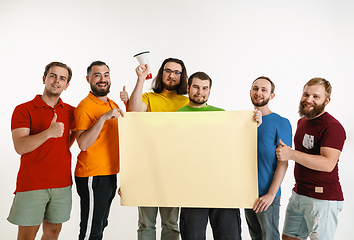 Image showing Young men weared in LGBT flag colors isolated on white background, LGBT pride concept