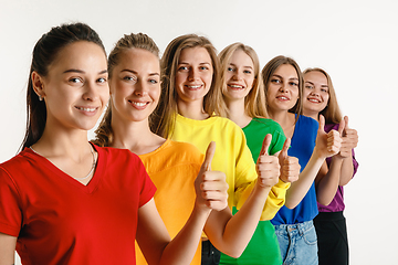 Image showing Young women weared in LGBT flag colors isolated on white background, LGBT pride concept